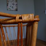Rattan wicker cradle on wooden wheels