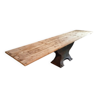 Old French industrial table with a cast iron base and a pine top.
