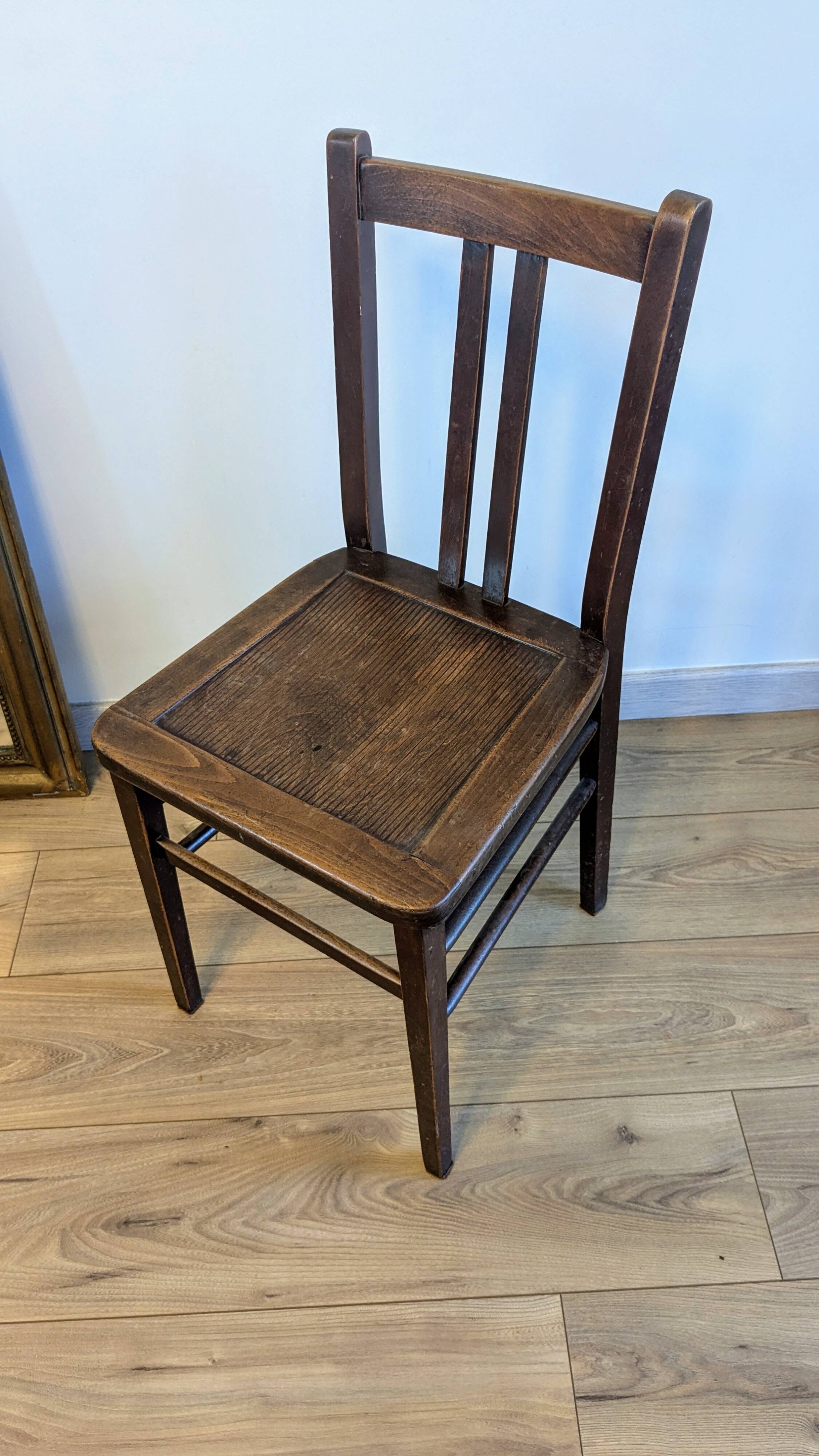 Pair of 1930s bistro chairs with patinated wood.