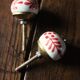 Pair of white and red porcelain drawer cupboard door knobs