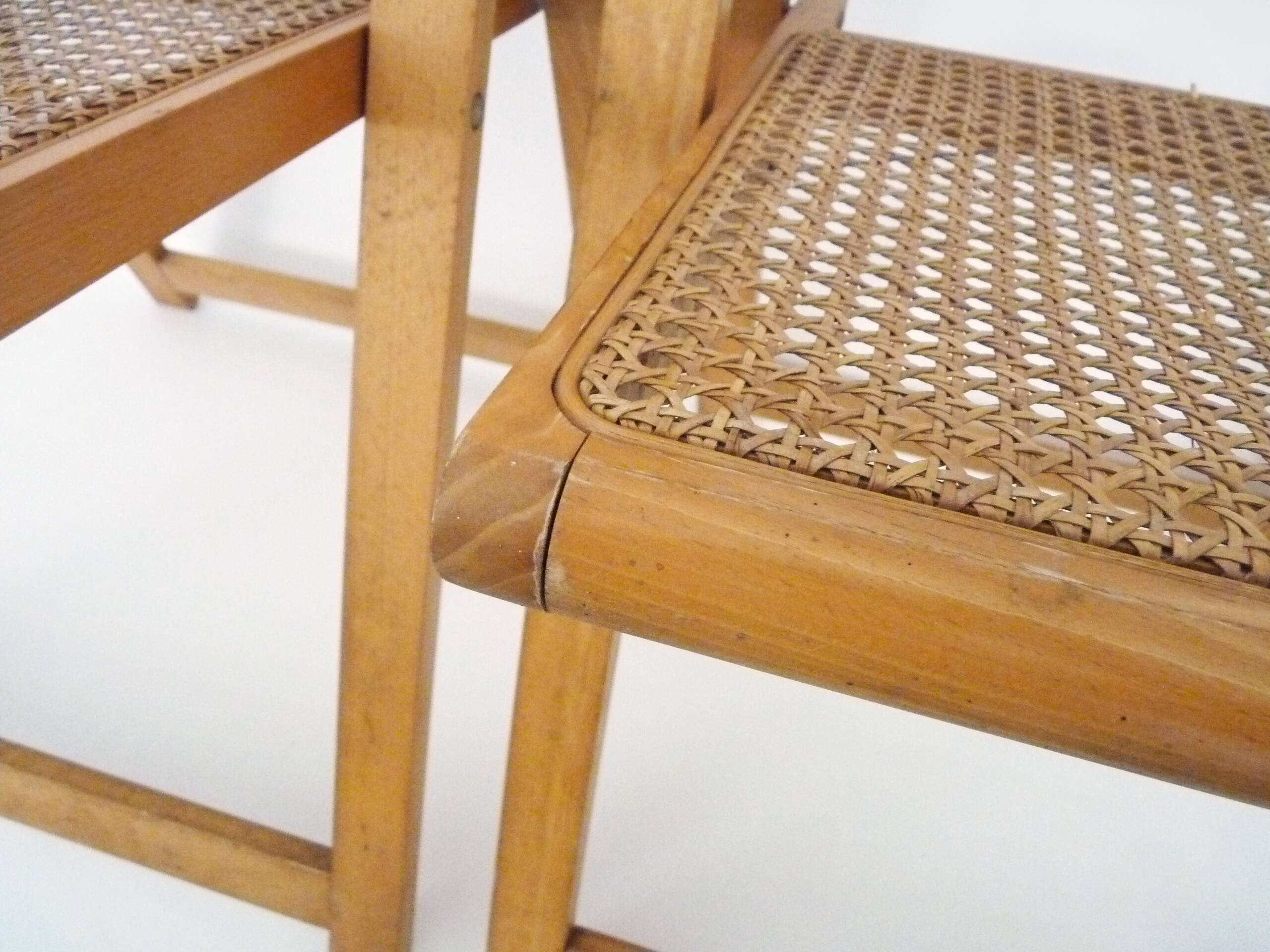 Pair of vintage folding chairs in beech and canework. Italy 70s