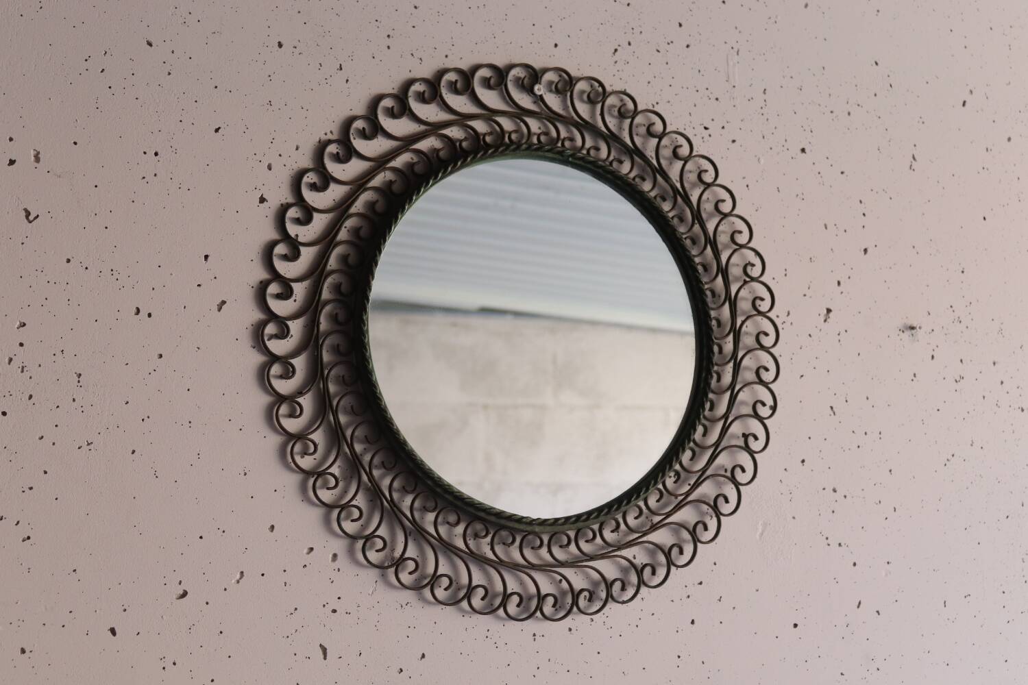 Large round vintage mirror in black metal with green patina