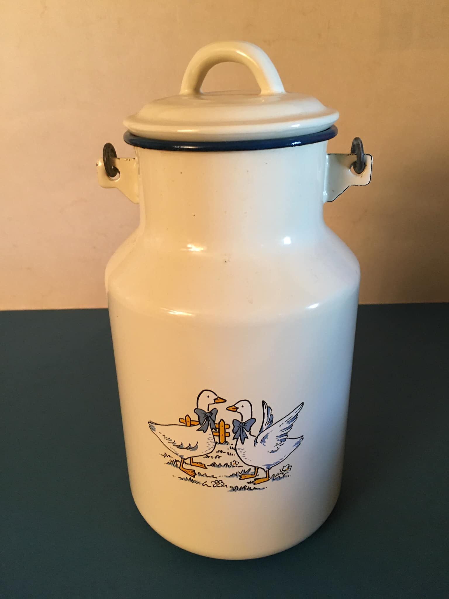 Enamelled milk jar retro style ecru color with "goose" patterns. Wooden handle.