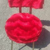 Red furry chairs and pouffe