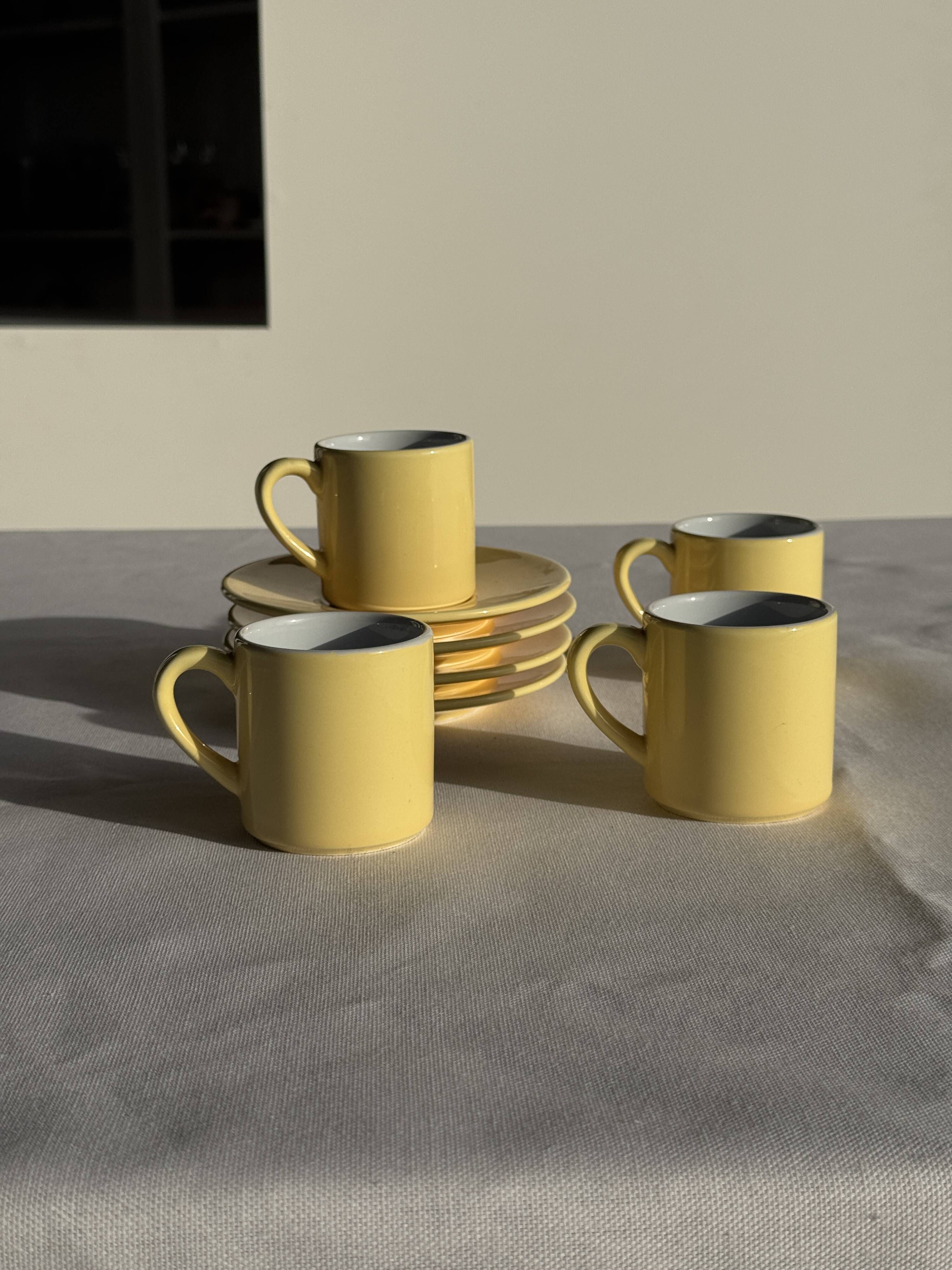 Set of 4 vintage yellow Italian espresso cups and saucers.