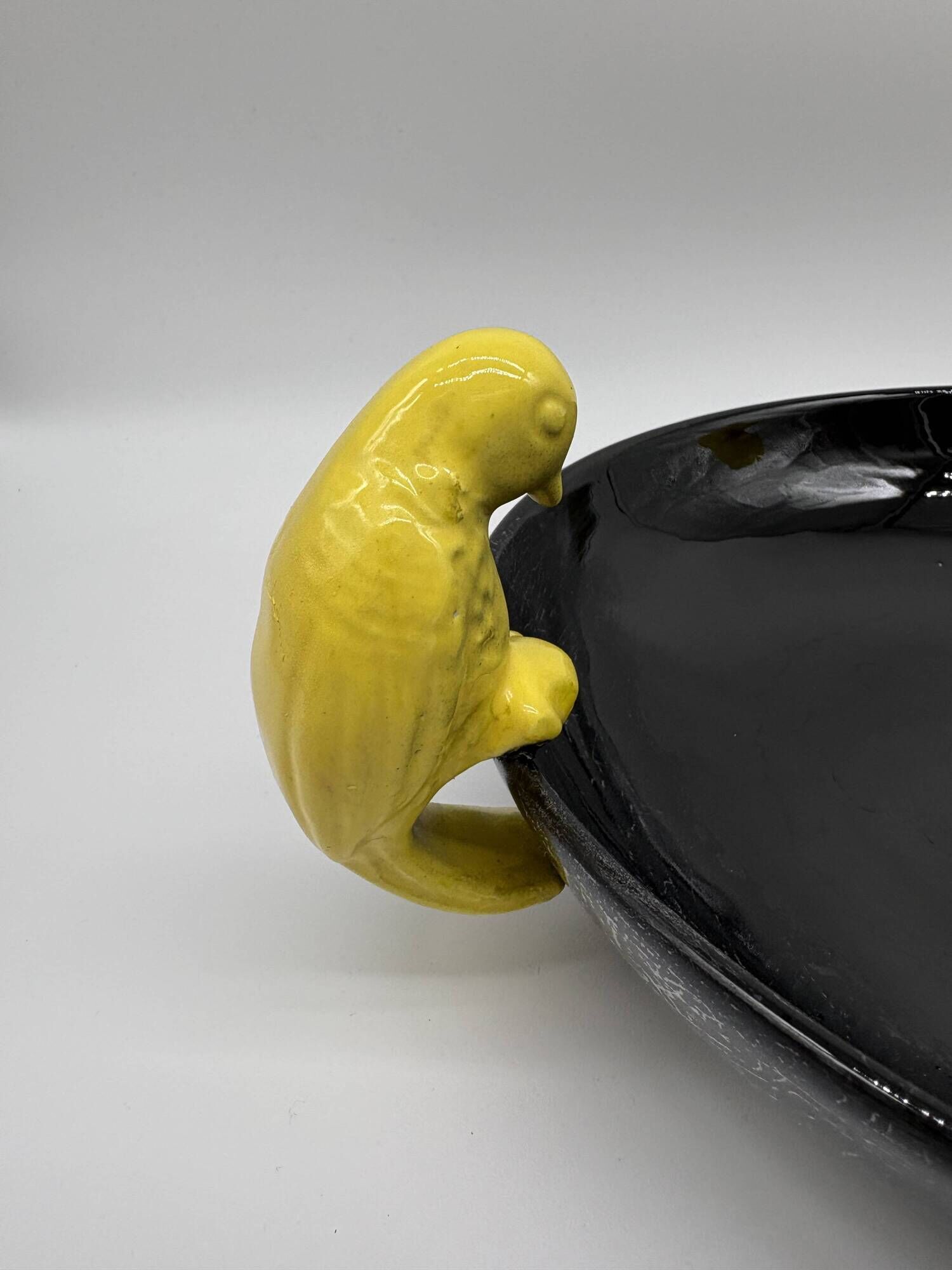 Large vintage black ceramic bowl with yellow parakeets, Vallauris.