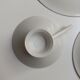 Solitaire tea cup, saucer, and dessert plate in white and gold.