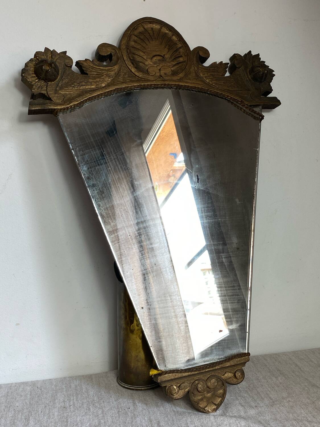Antique wooden mirror with an unusual shape