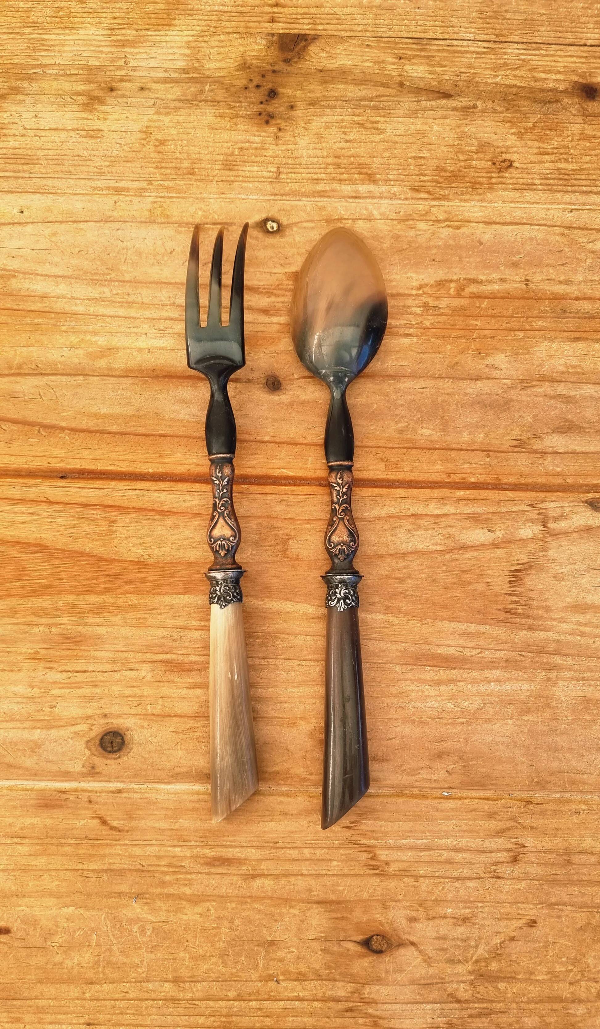 Vintage serving cutlery in horn and wrought metal