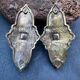 Pair of bronze wall sconces with mask, signed L. Pinet, Art Nouveau period.
