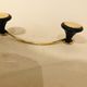 Gold and black metal coatrack 1960