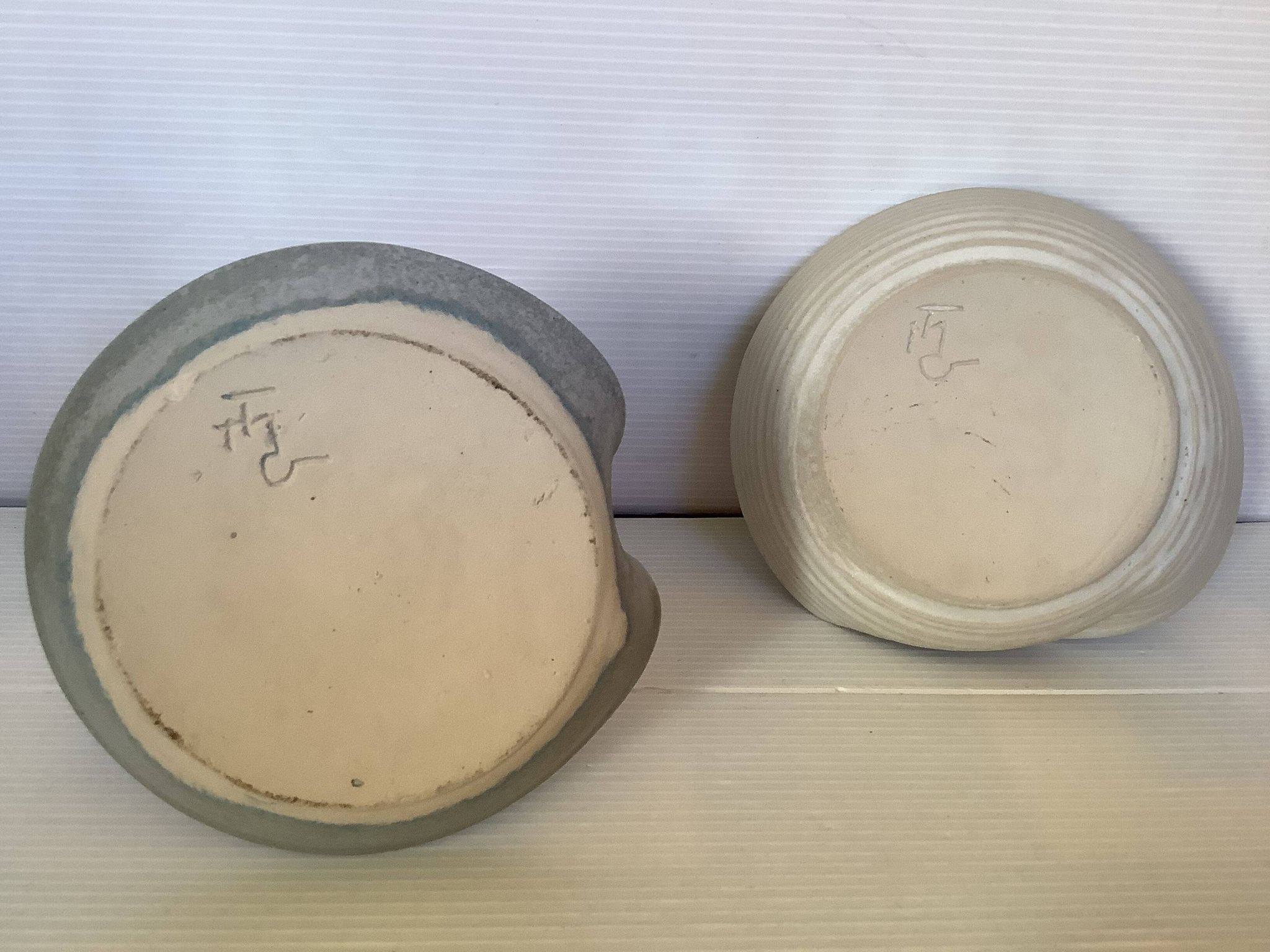 Pair of signed ceramic candlesticks