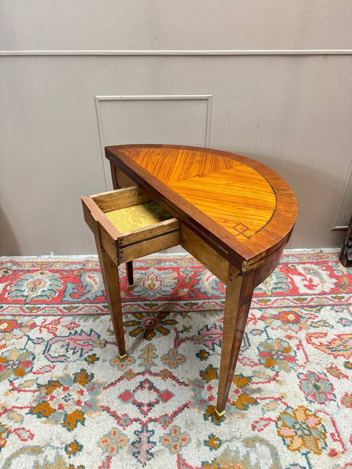 Half-moon game table in marquetry from the Louis XVI period, 18th century.