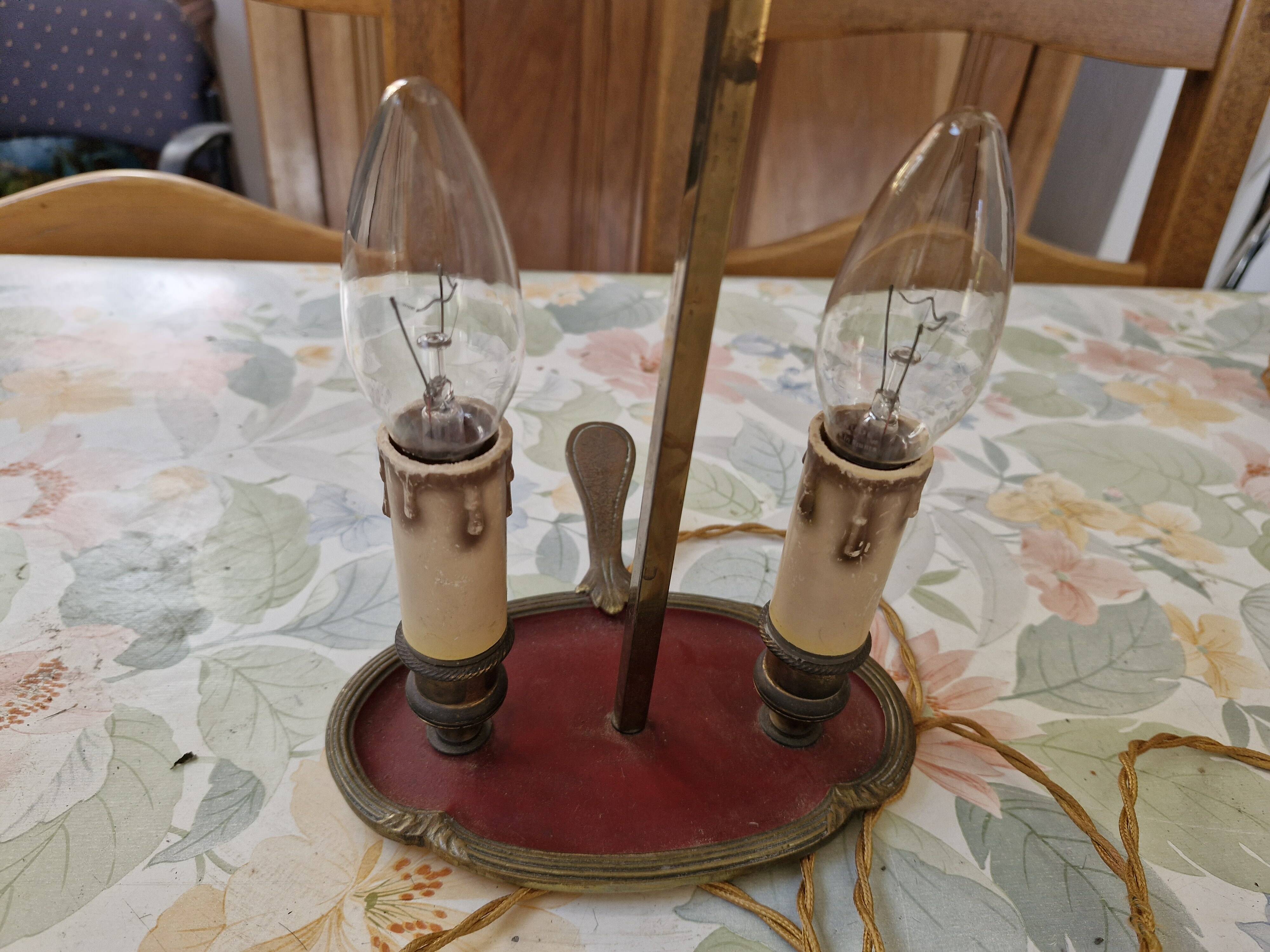 Old silver-plated bronze lamp, except for the arms which are not silver.