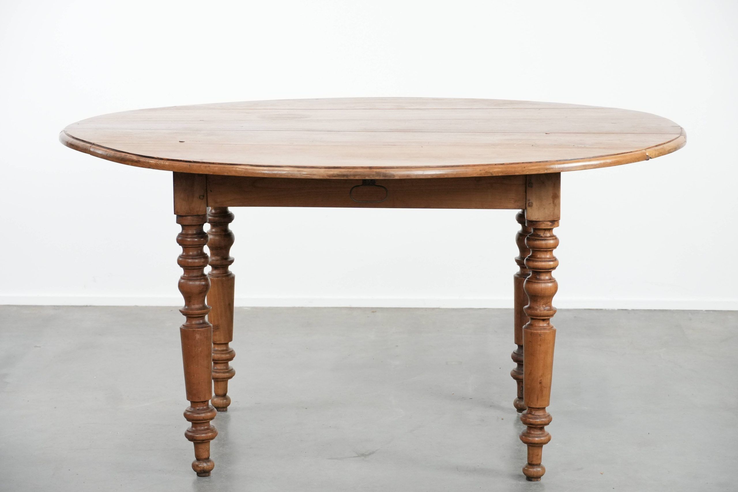 Antique English drop-leaf dining table made of walnut with elegant legs