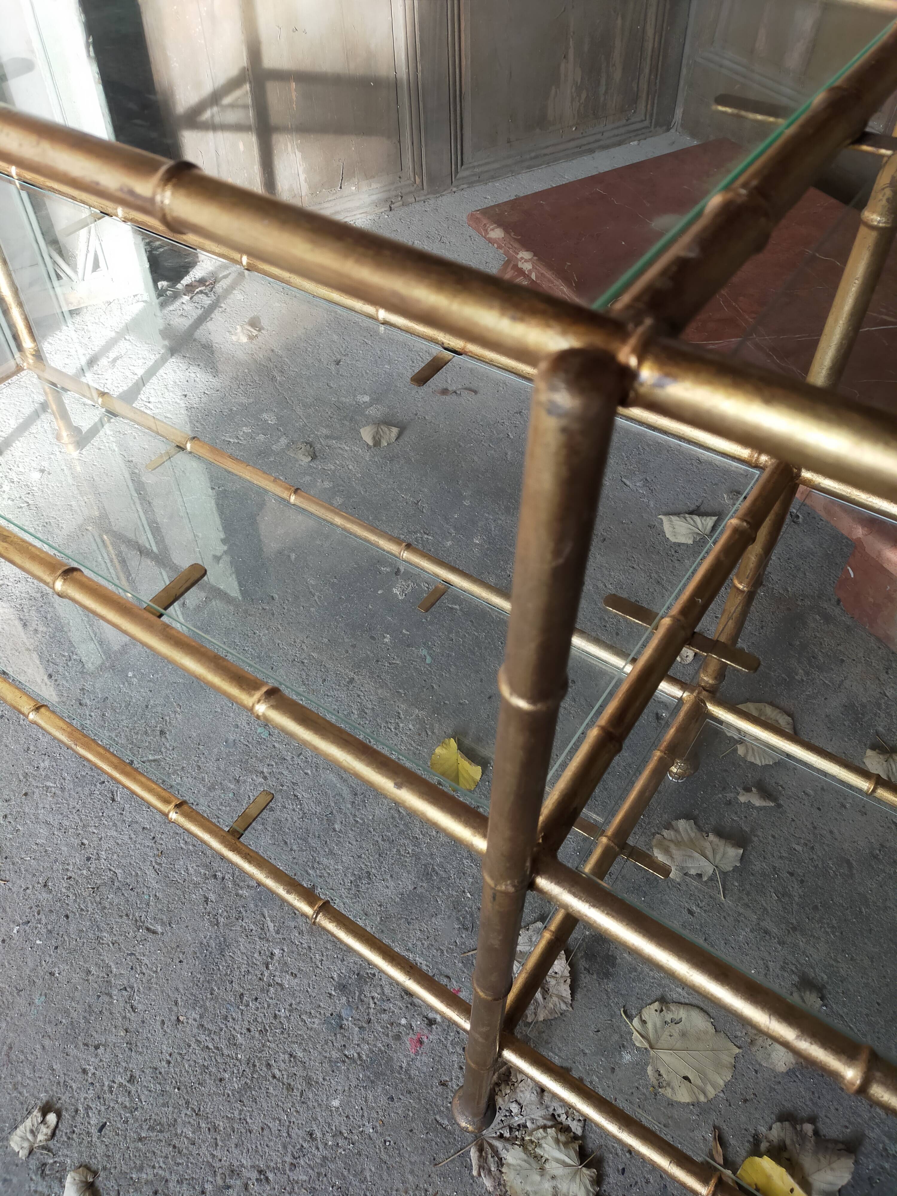 Console in gilded metal and glass