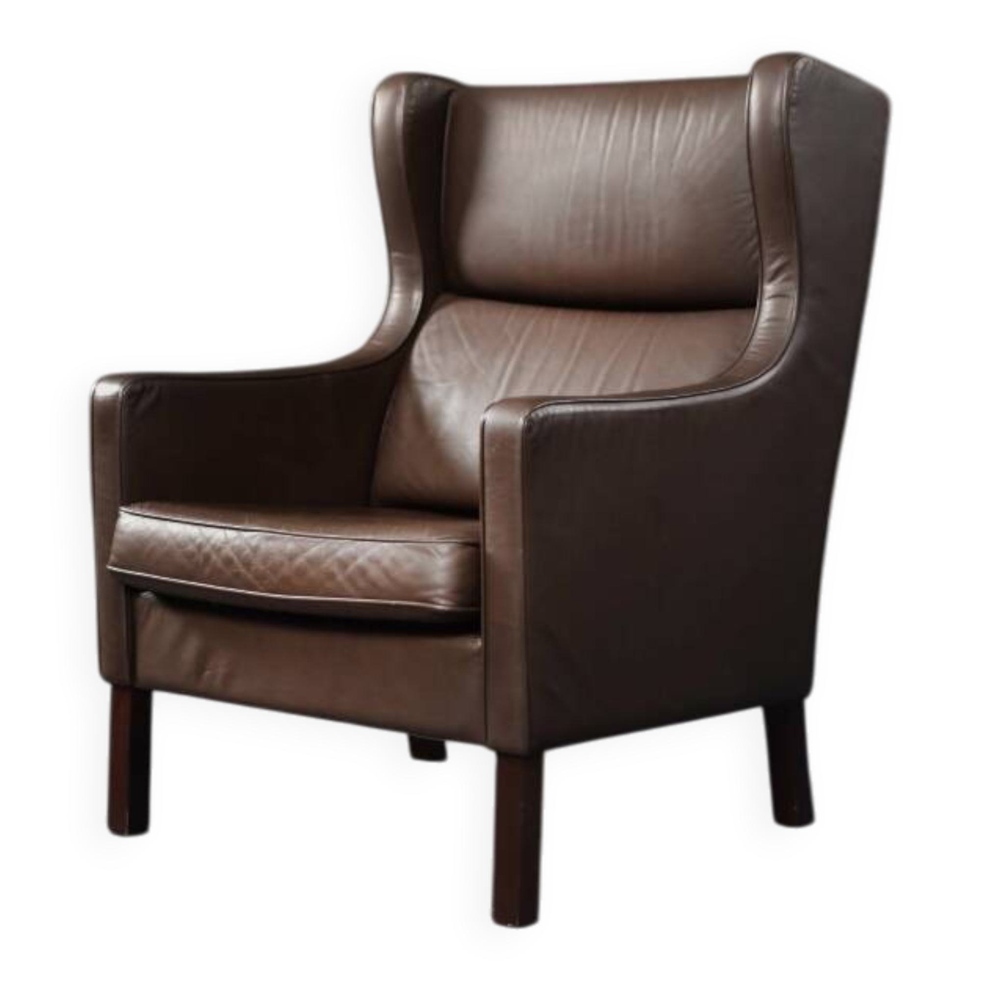 Brown leather wingback chair in mid-century modern Danish style, 1960s.
