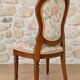 Antique Louis XVI style chair in wood and floral fabric.