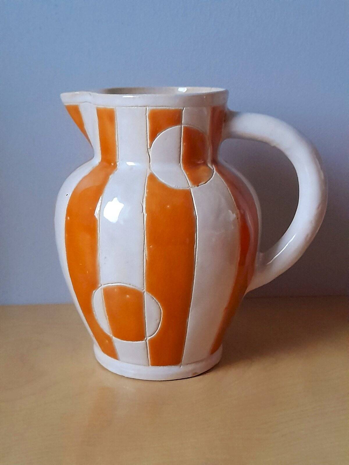 Old enamelled ceramic jug