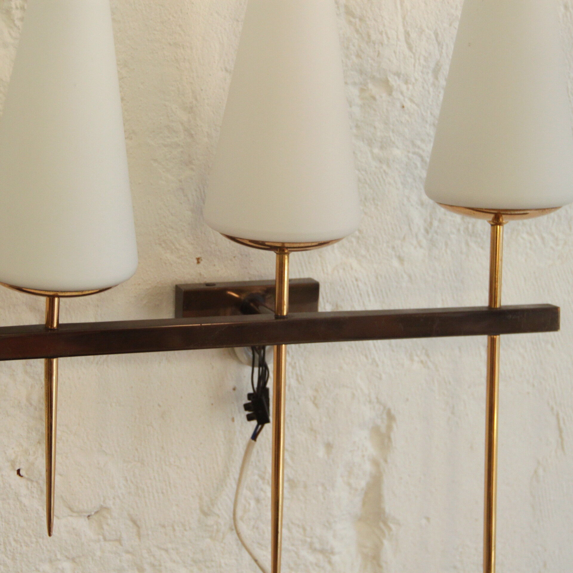 Old wall in brass and white opaline glass tulip