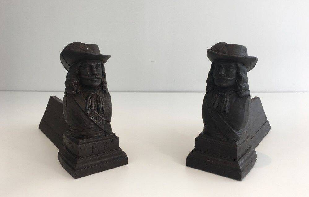 Pair of cast iron andirons in the likeness of a musketeer