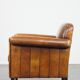 Sheepskin Art Deco design armchair with sleek finish and black piping