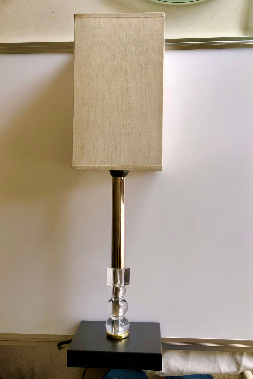 Silver floor lamp with a straight shade.