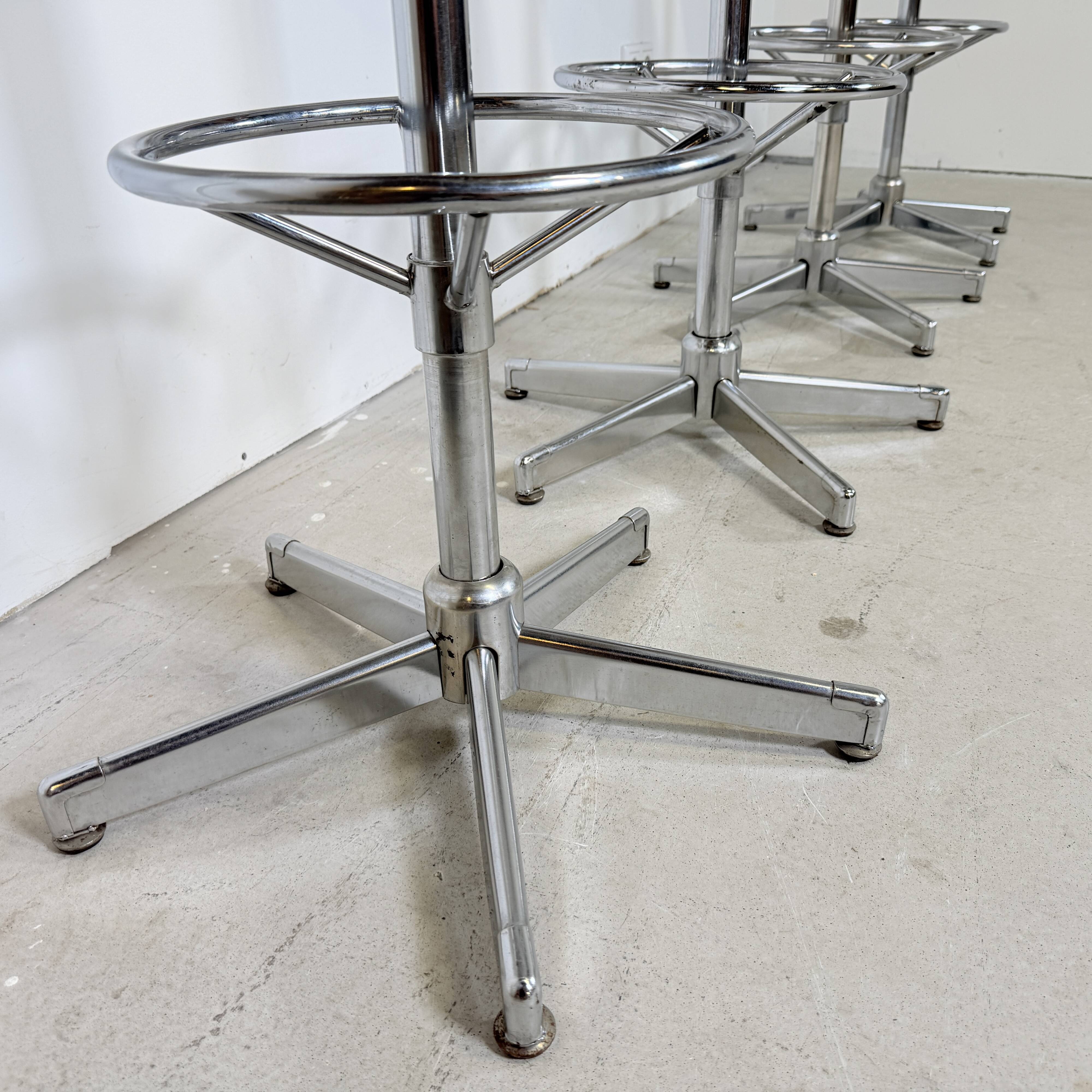 1970s chrome bar stools with cognac-colored faux leather upholstery