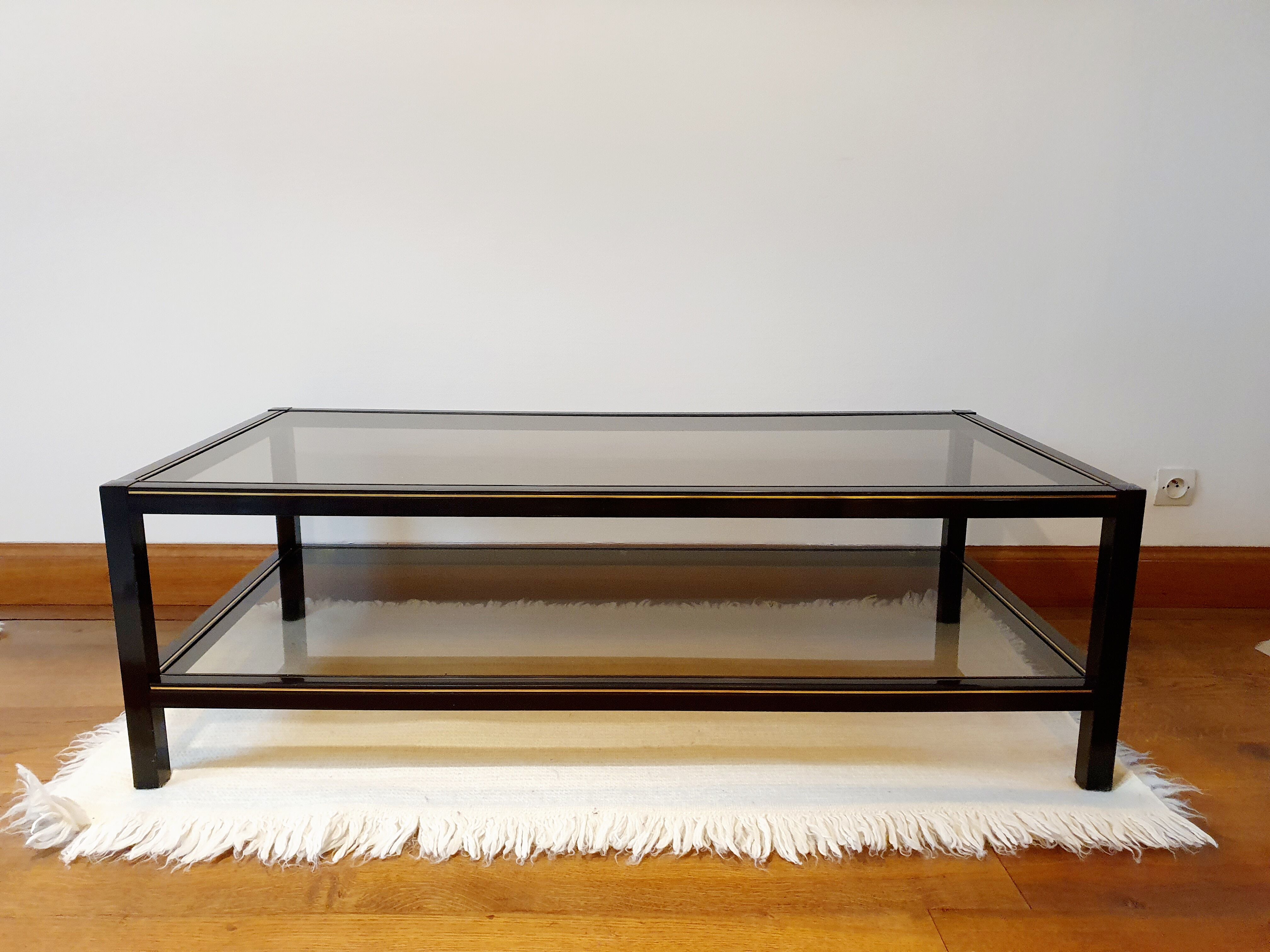 Black and gold coffee table with a double smoked glass top