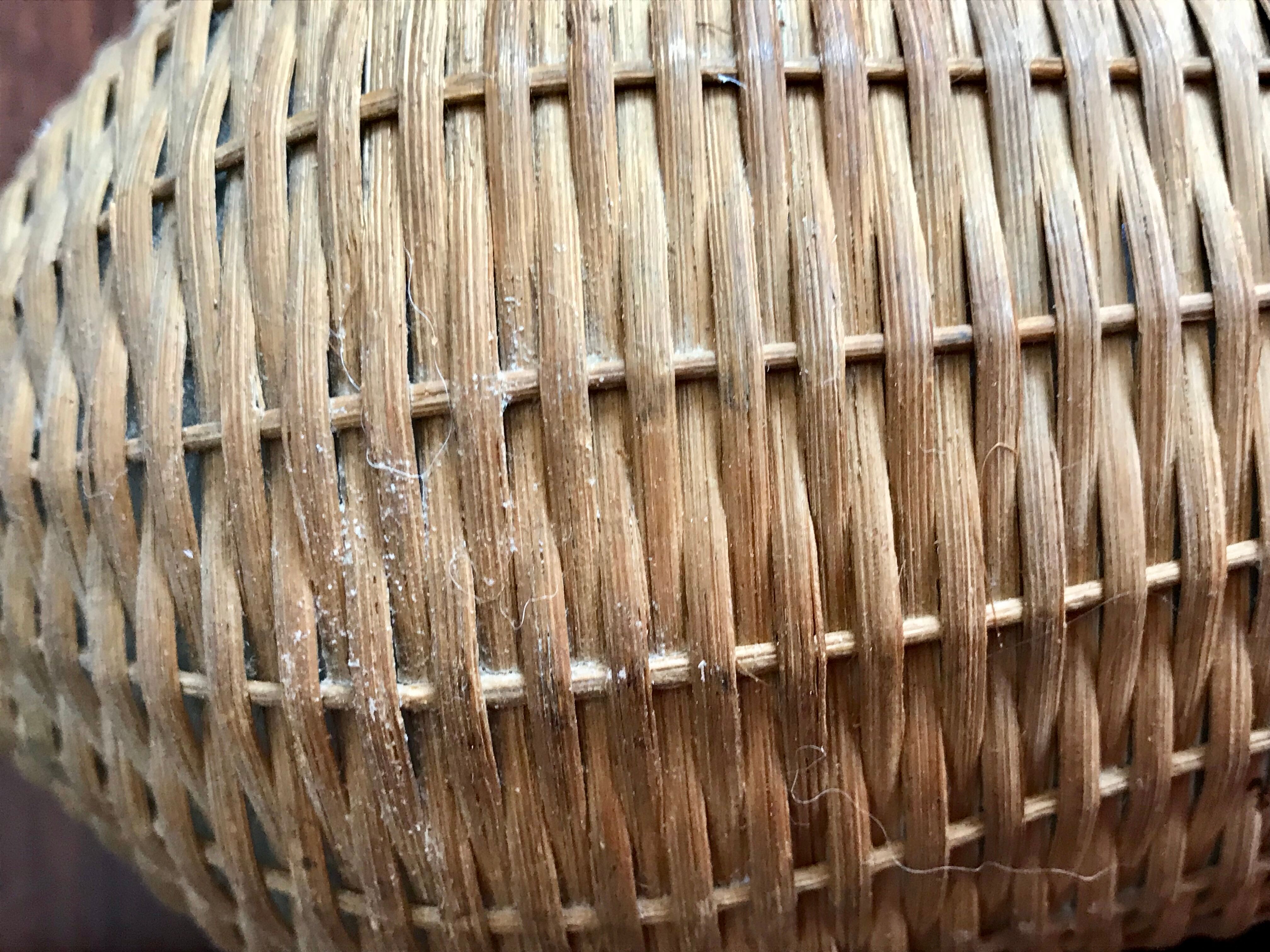 Set of three vintage rattan bottles