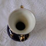 Revol porcelain vase, showcase object, romantic decor, blue background, golden handles