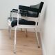 Pair of black skaï and chrome armchairs