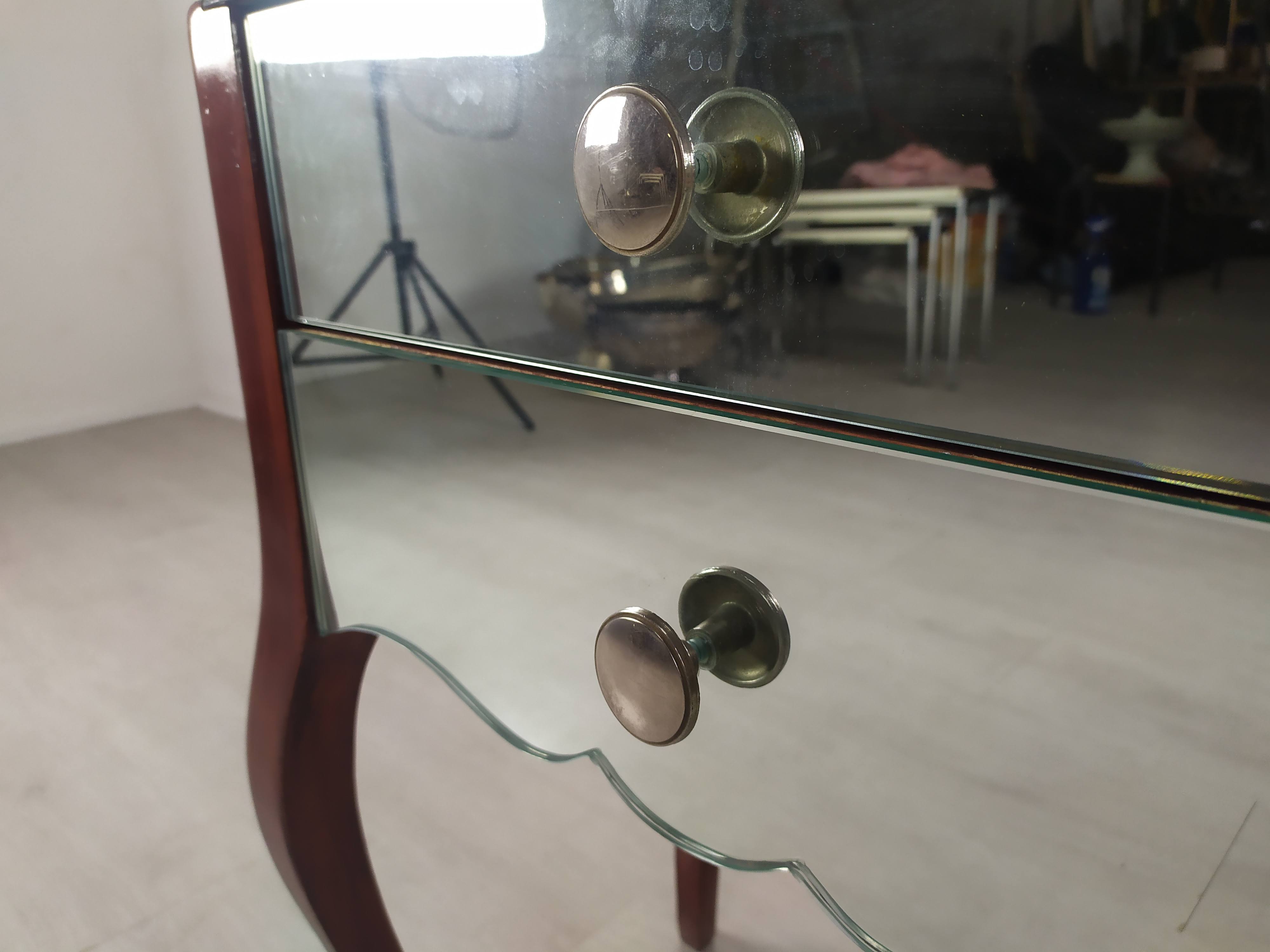 Glass art deco mirror beside table