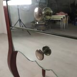 Glass art deco mirror beside table