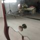 Glass art deco mirror beside table