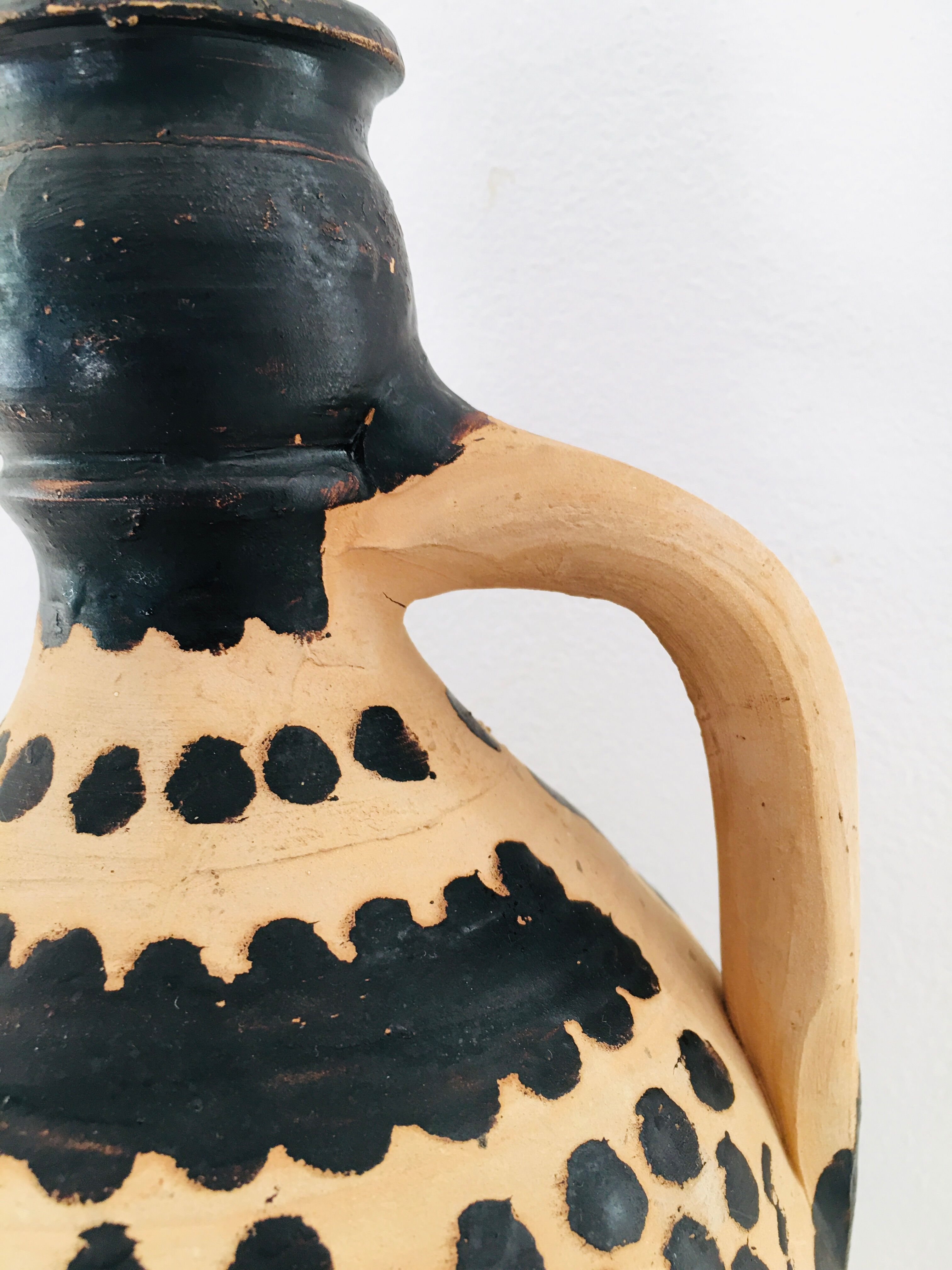 Raw and black terracotta jug