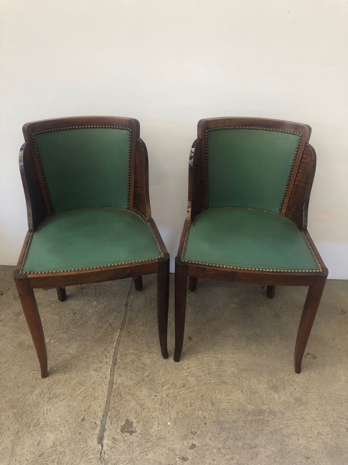 Pair of old wood and green leather gondola chairs