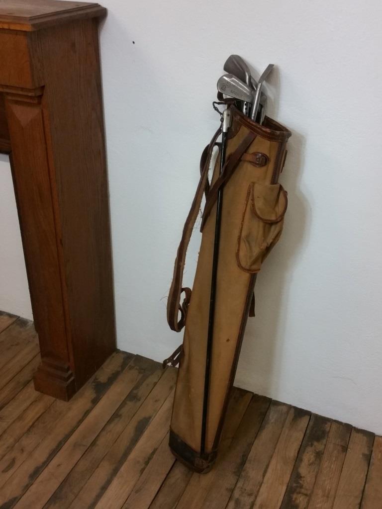 Old golf bag with 5 golf clubs