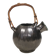 A ceramic jug with a metallic glaze and a handle made of woven raffia.