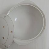White earthenware soup tureen with a golden pattern.