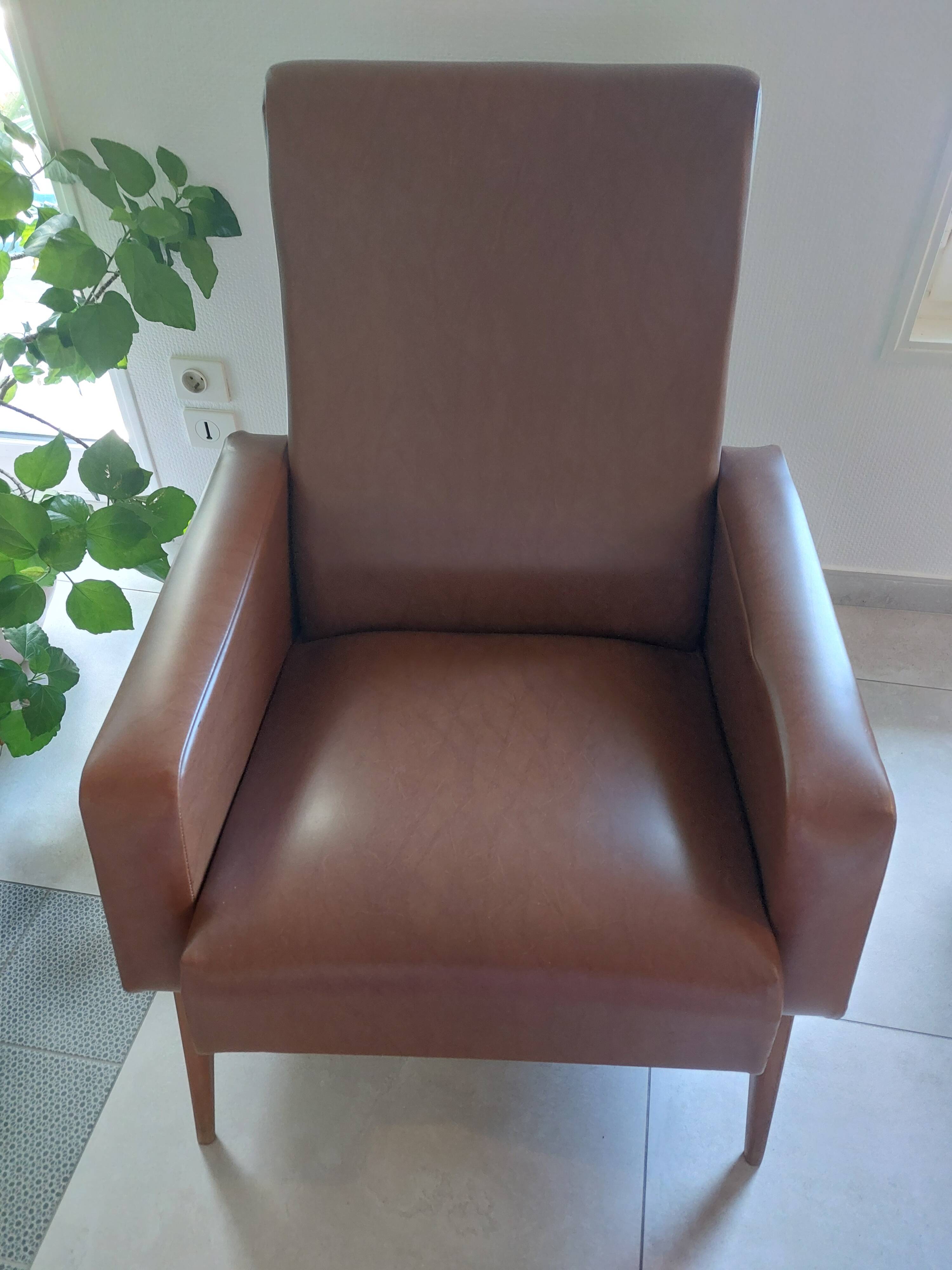 a pair of comfortable vintage armchairs with splayed legs