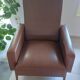 a pair of comfortable vintage armchairs with splayed legs