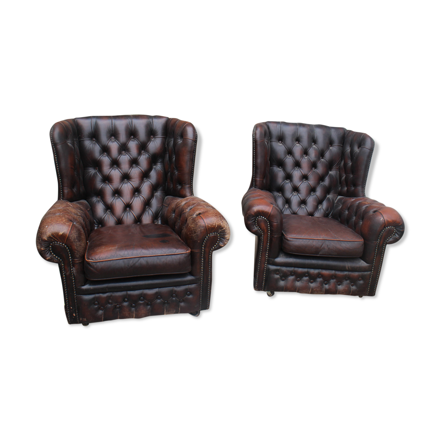Padded chesterfield leather armchairs