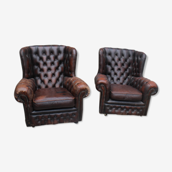 Padded chesterfield leather armchairs