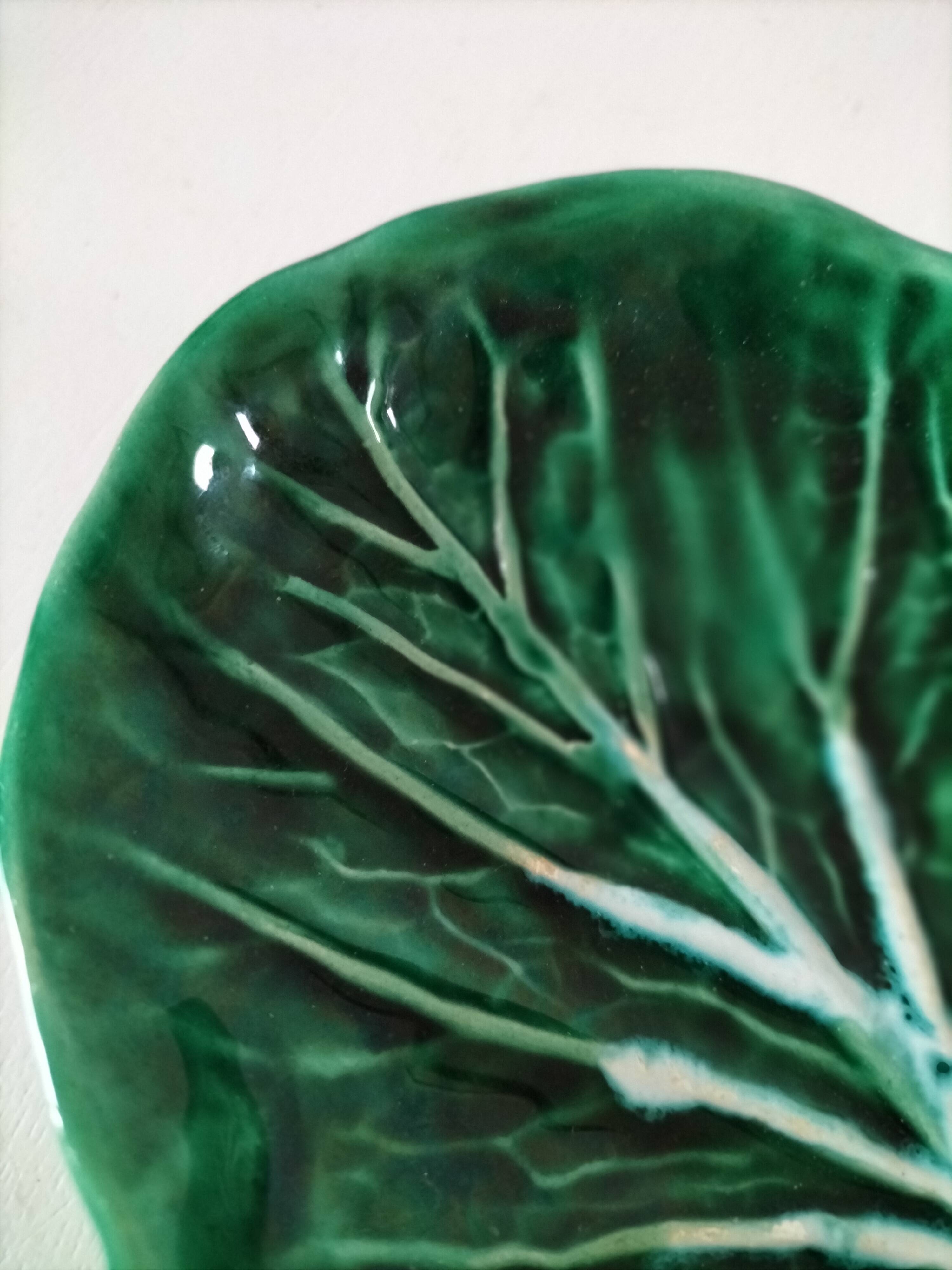 Vintage green slipware bowl in the shape of a cabbage leaf.
