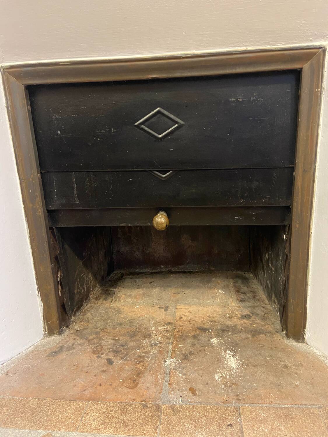 Marble fireplace surround with closed hearth frame.