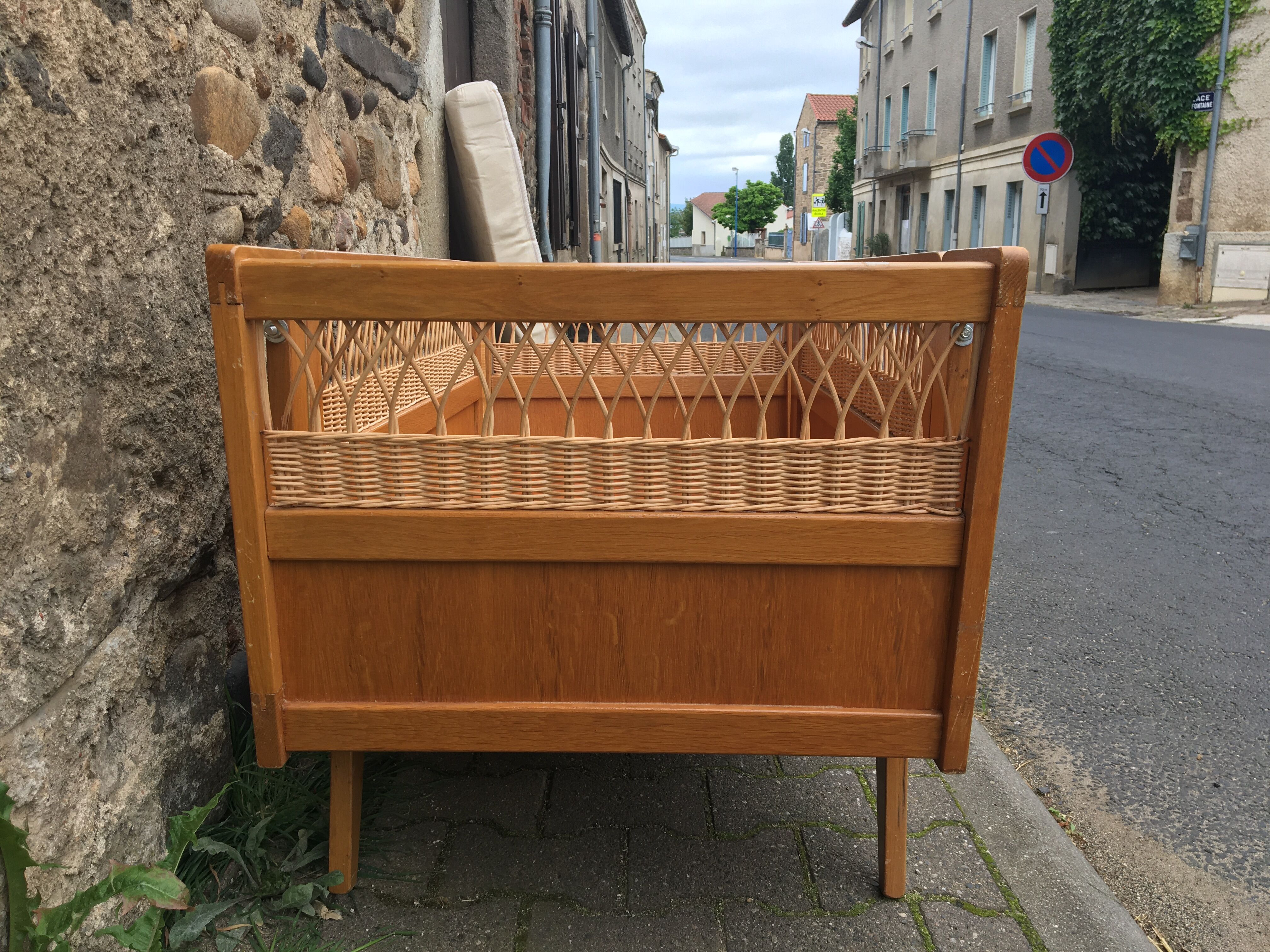 Wooden and rattan baby bed