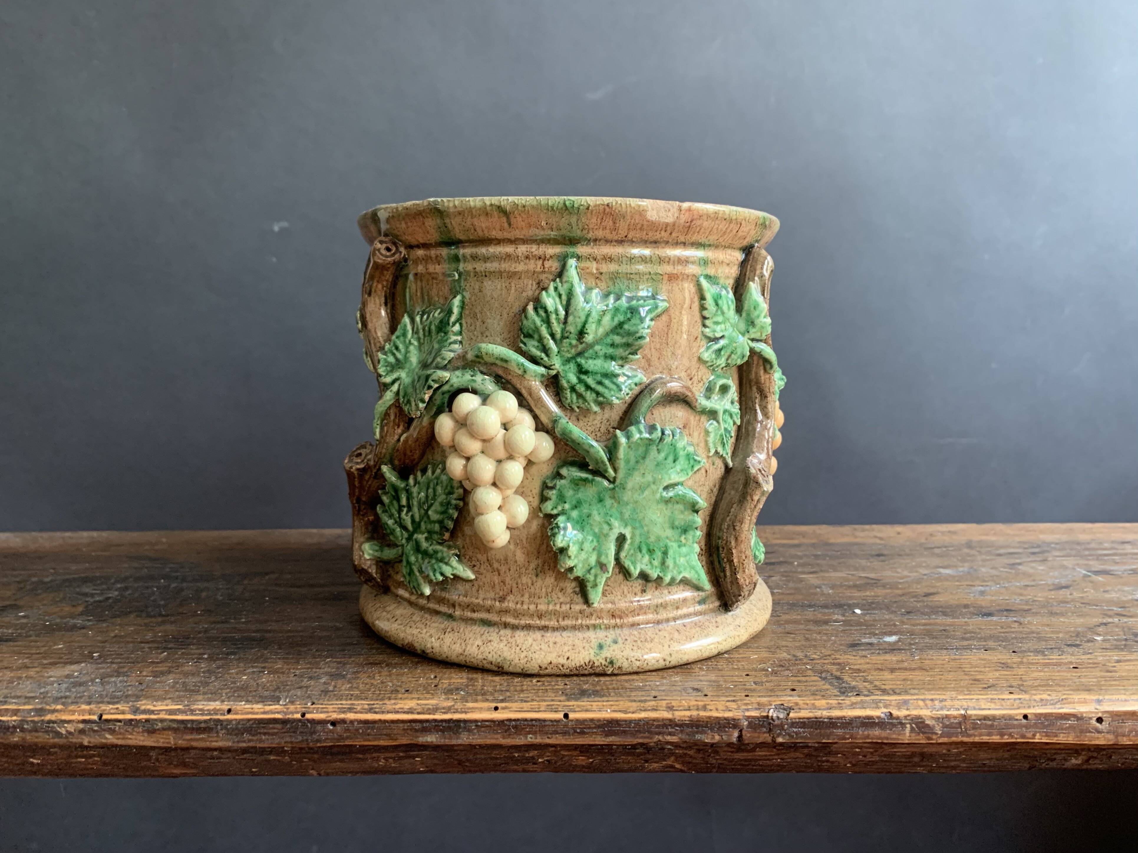 Large 19th century slip pot with vine decoration