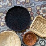 Set of 7 black and natural wicker baskets.