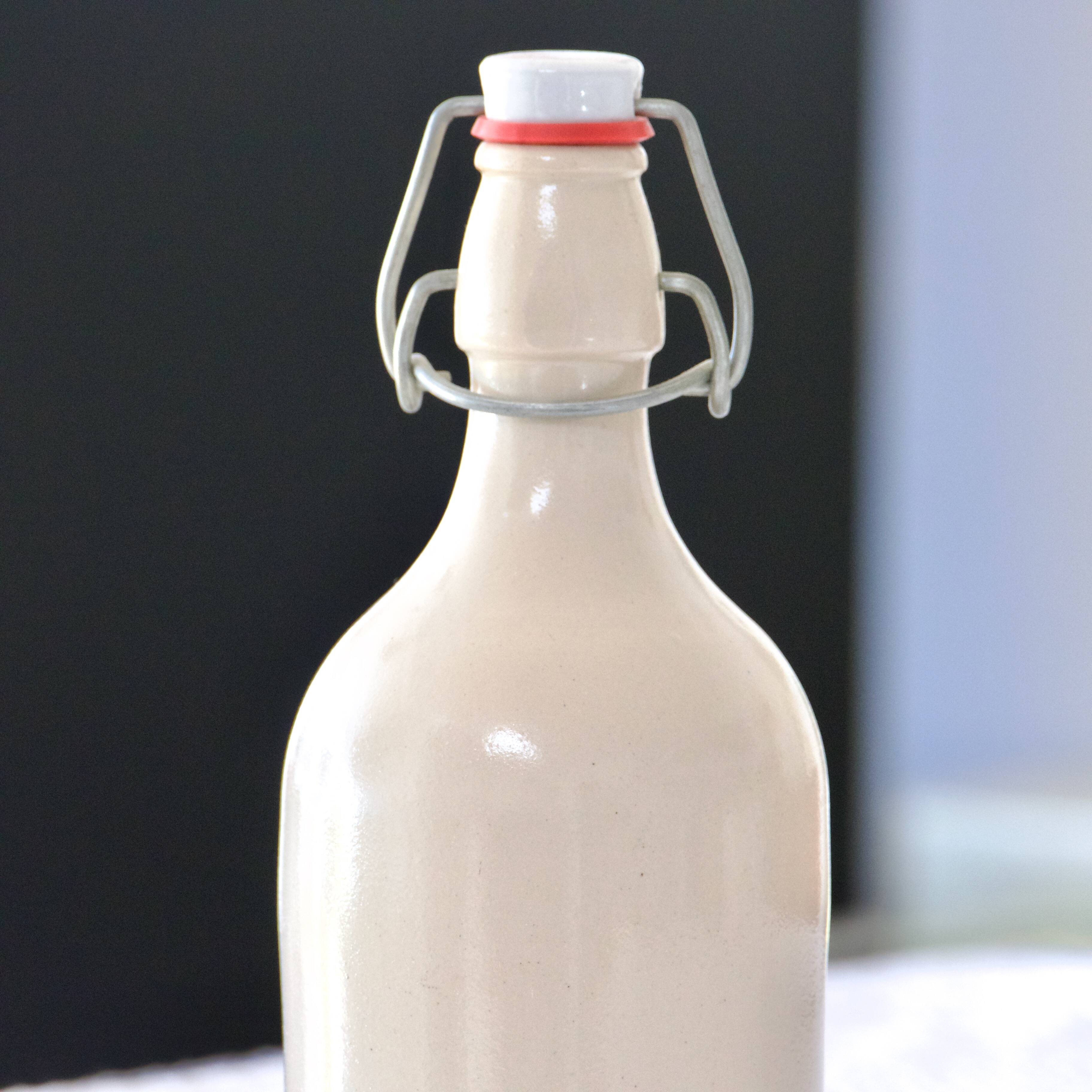 Antique enamelled stoneware beer bottle signed MKM